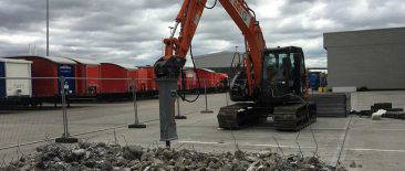Demolition work with an excavator breaking up concrete - J & A Groundworks