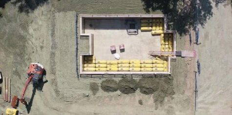 Construction site with heavy machinery, including an excavator and diggers - J&A Groundworks